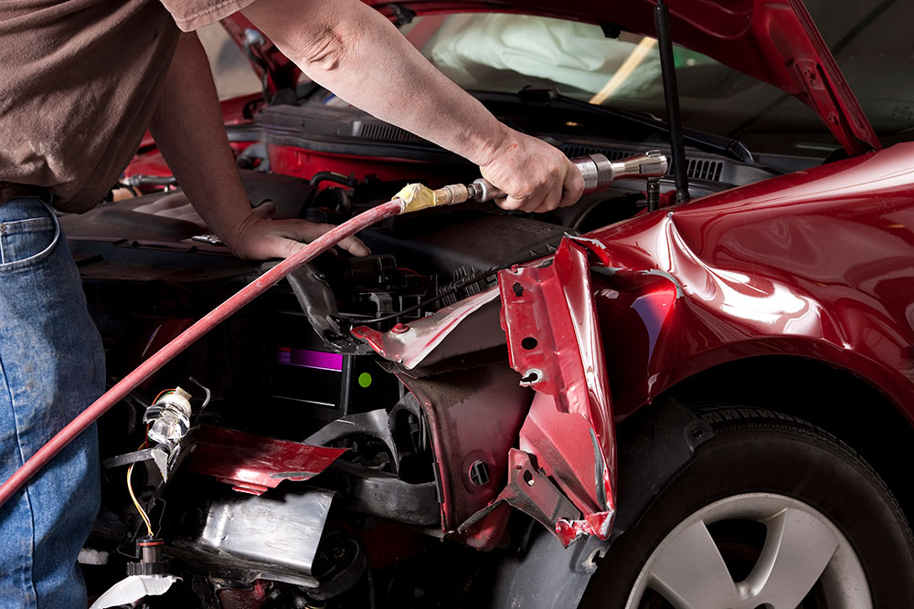 Auto Body Mechanic Disassembling Damaged Vehicle